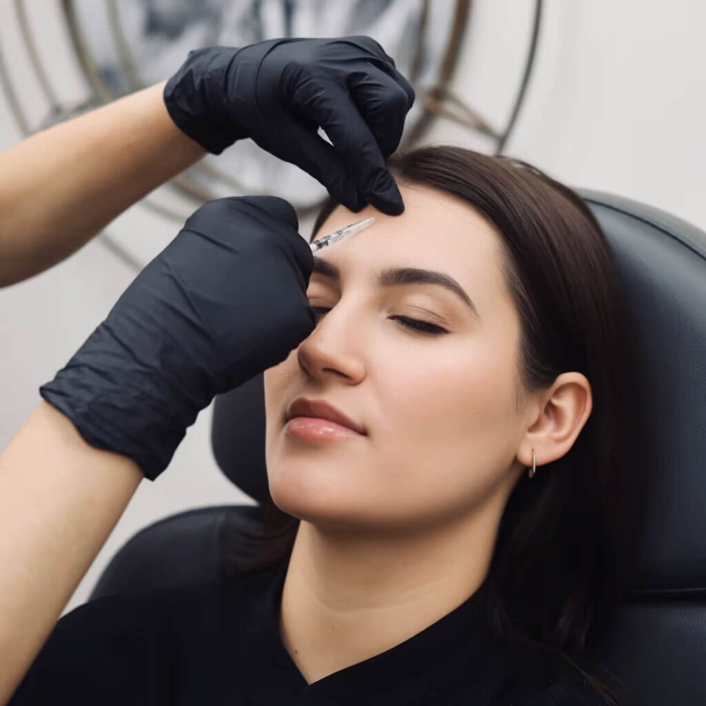An injector marking and treating a patient's brow with a neuromodulator