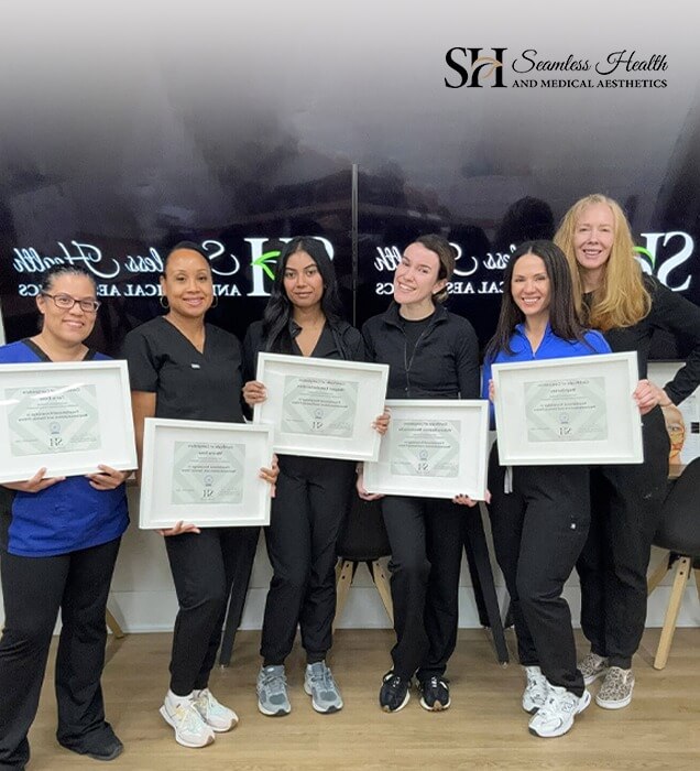 Seamless Health training graduates holding their certificates in the clinic