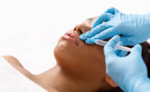 Patient receiving a lip injection from a gloved injector